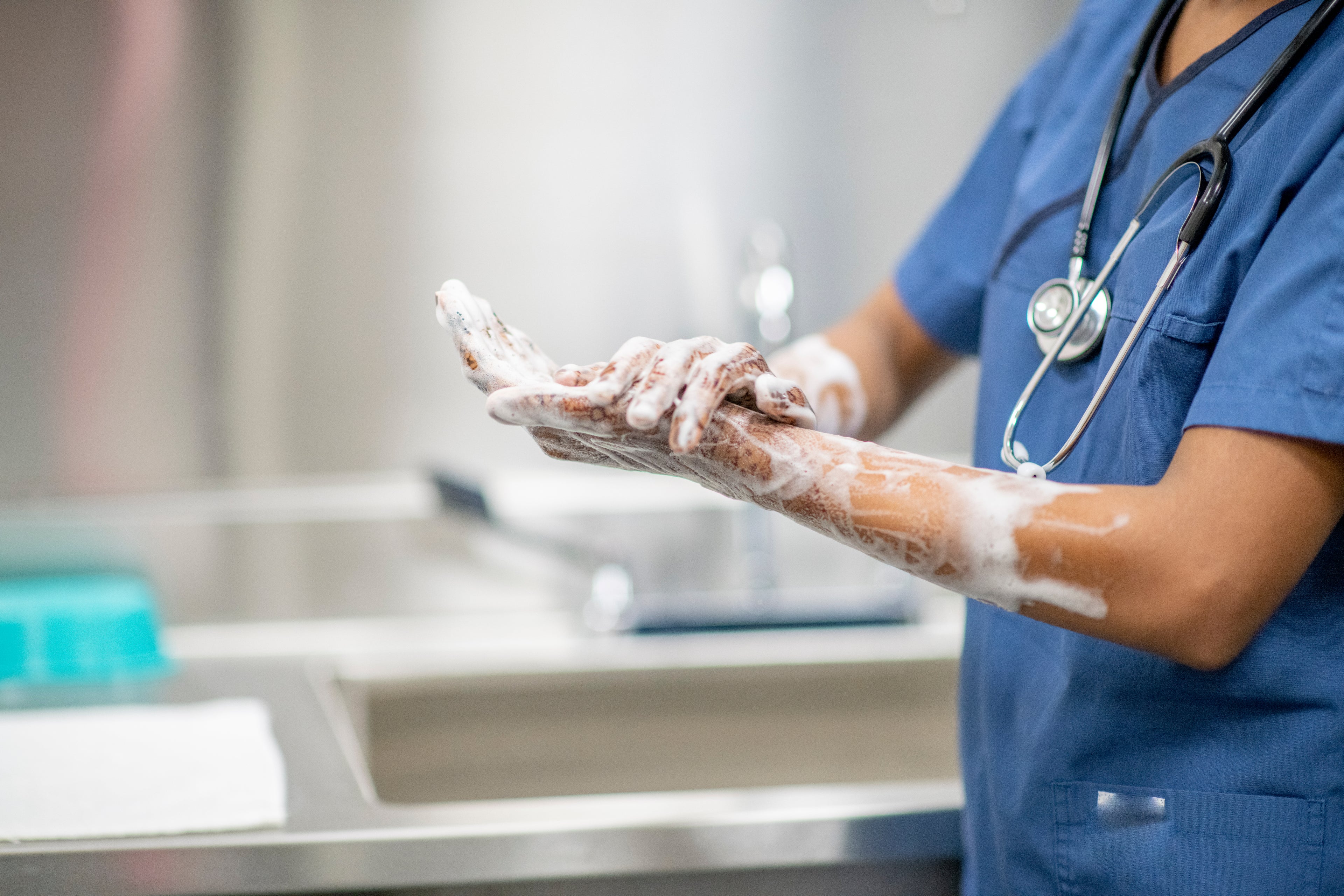 Doctor washing their hands with soap