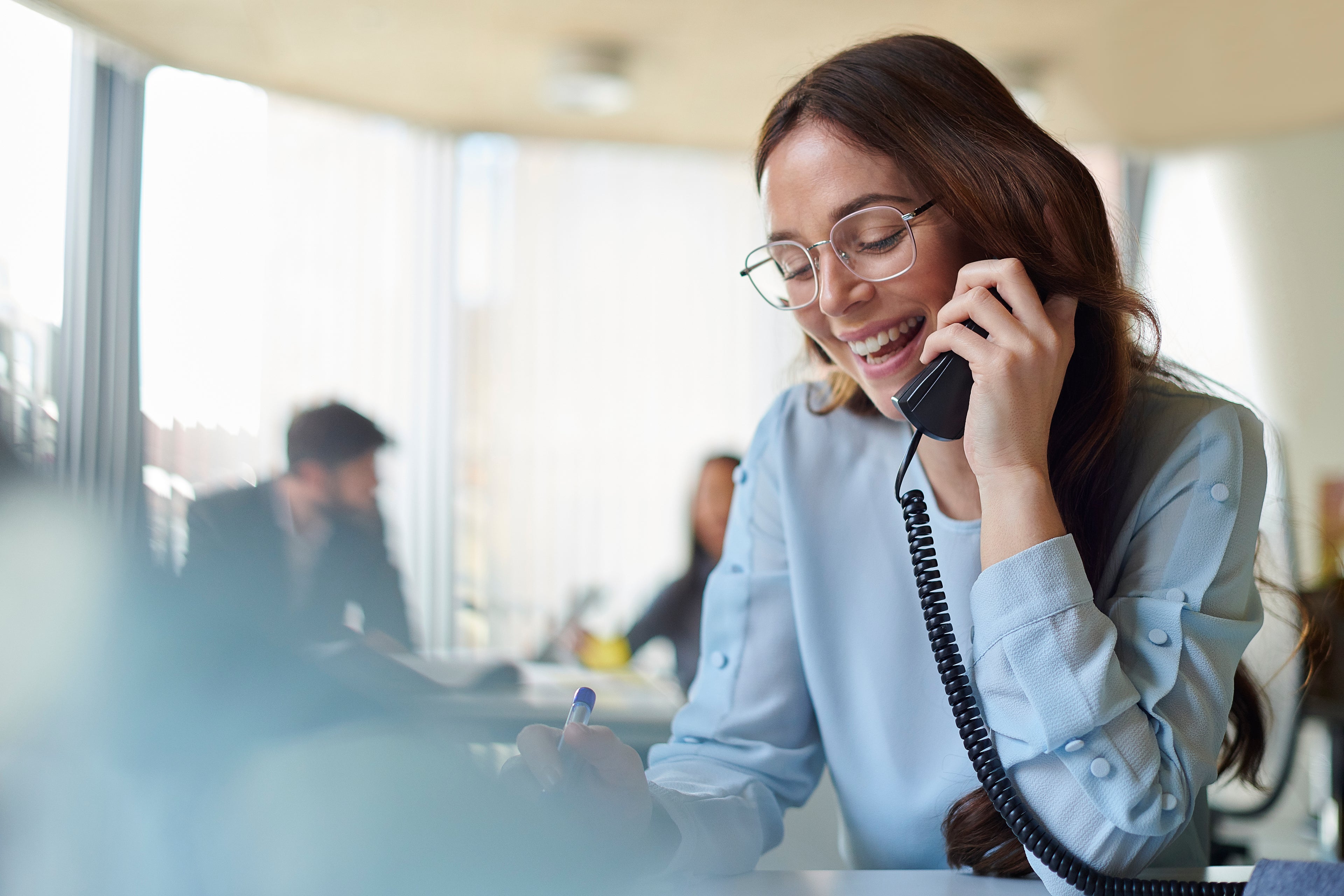 woman smiling while on telephone