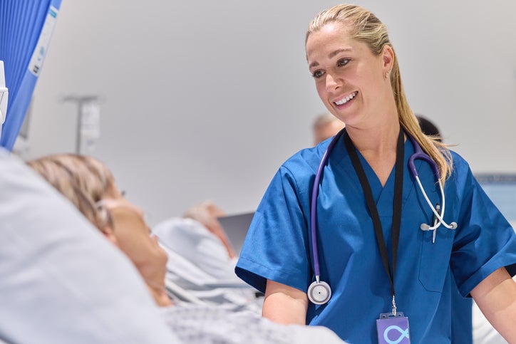 Smiling Female Doctor Talking With Patient