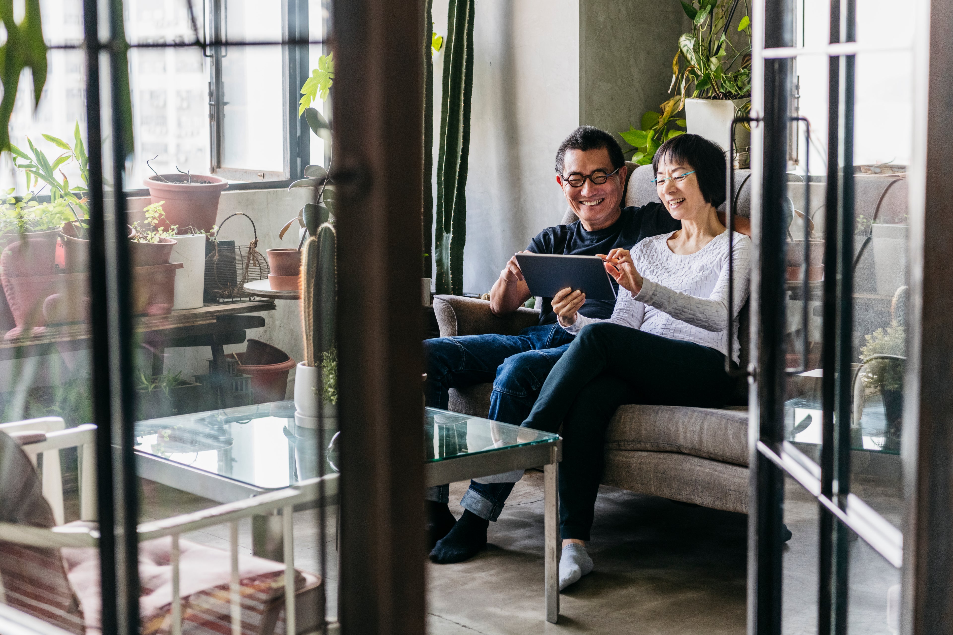 Couple in home looking at a digital tablet. 