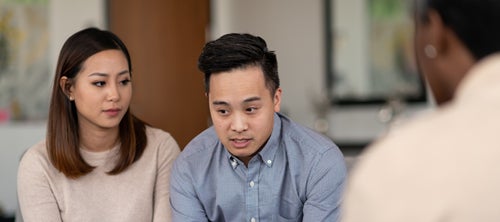 two people talking and looking concerned