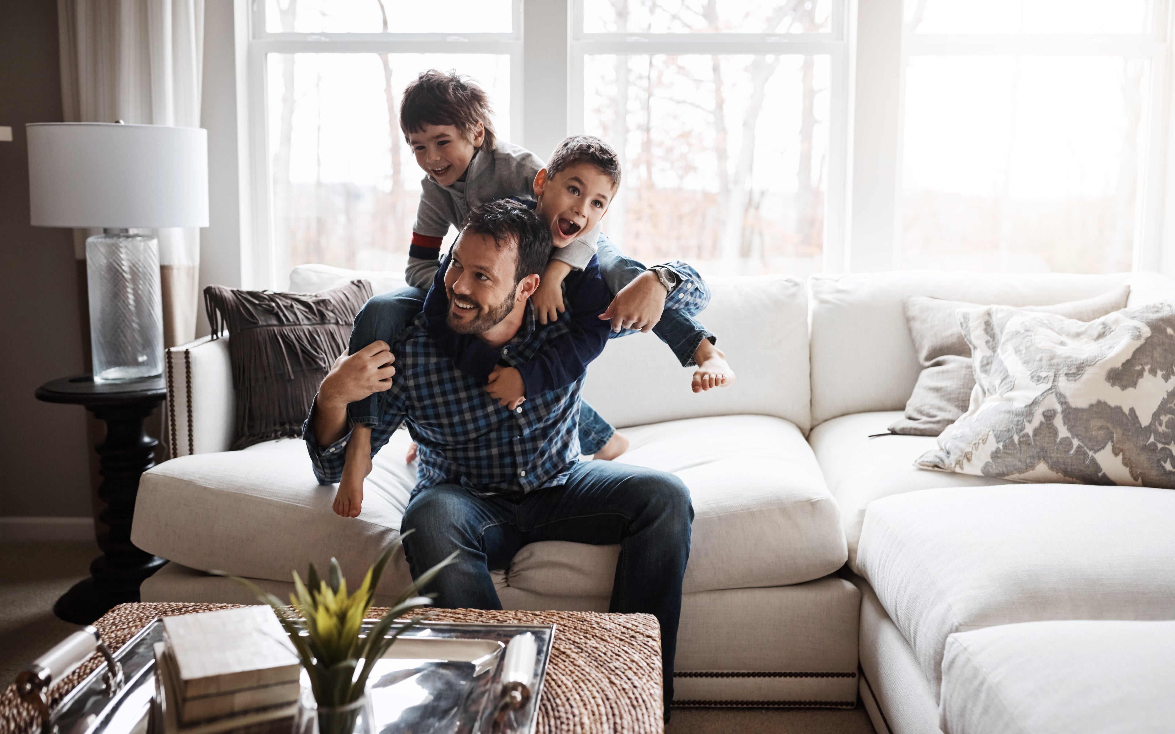 Dad with two sons on laptop at home. 