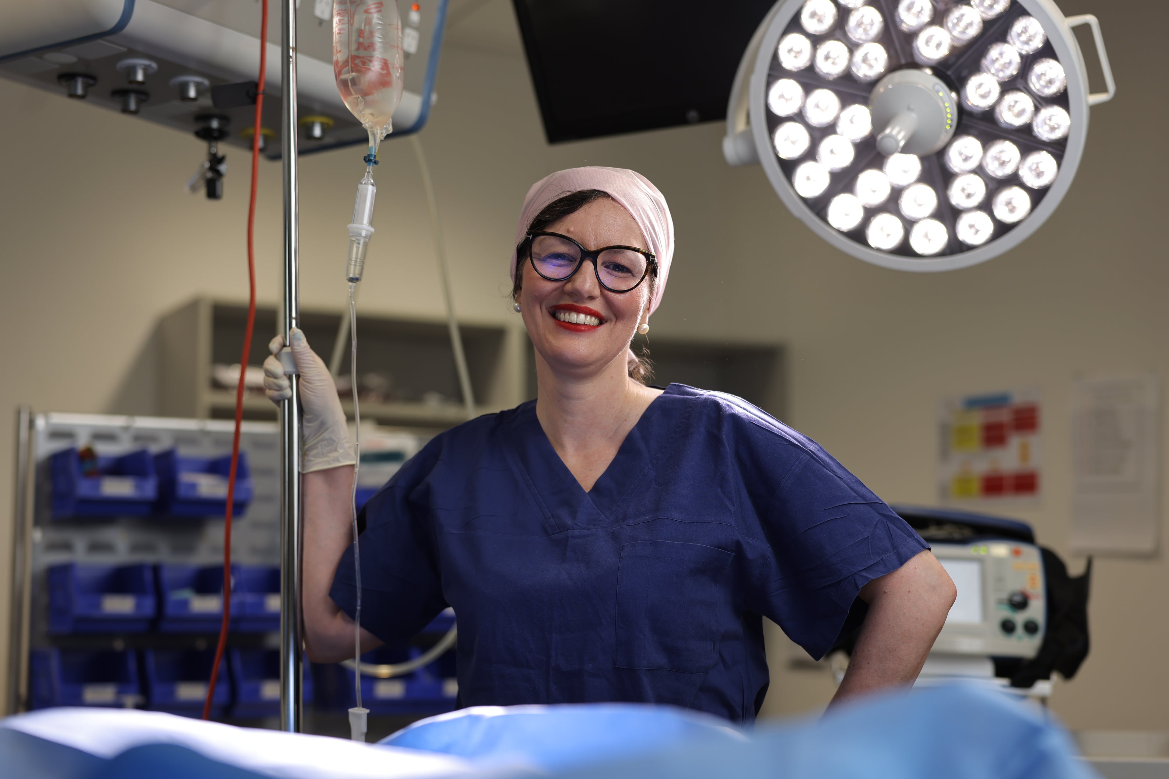 Professor Aitken standing in operating theatre