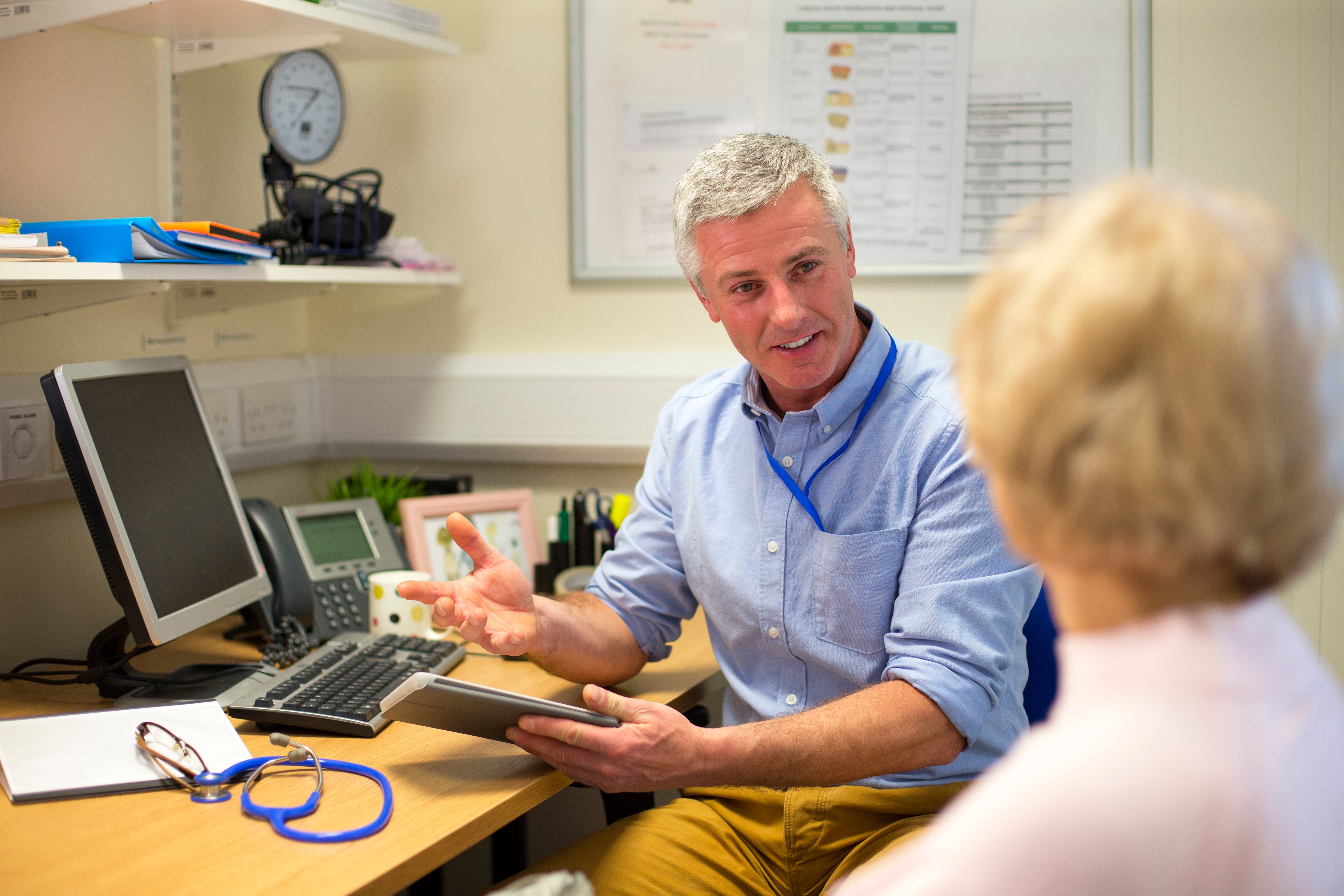 Doctor and patient looking over computer 