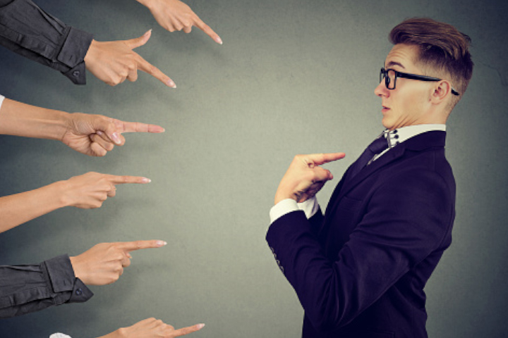 Workplace team festivities and pointing at one team member