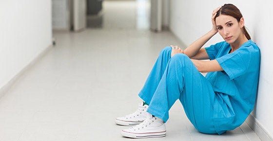 Doctor sitting on floor in hallway