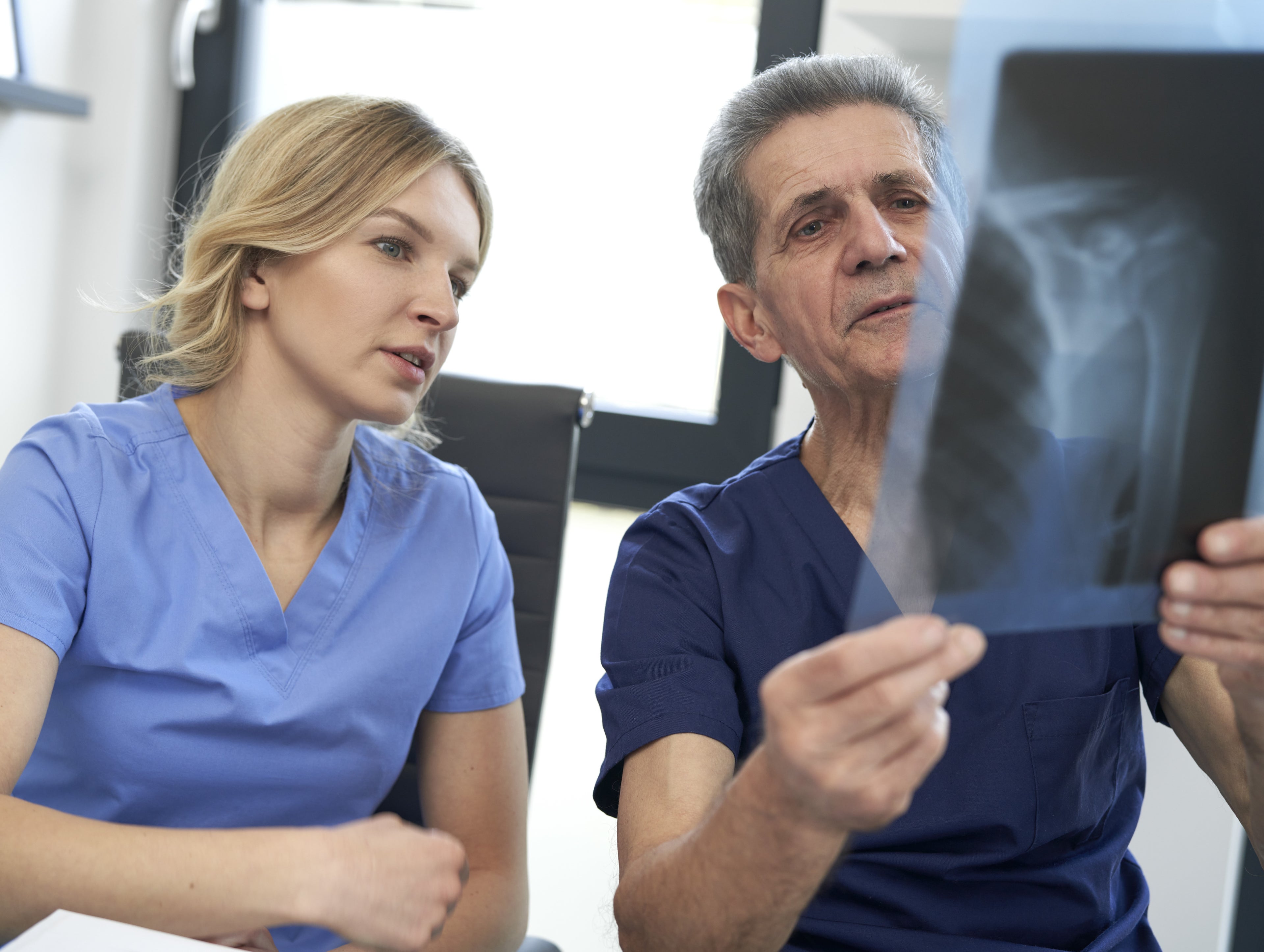 doctors looking at x-ray film