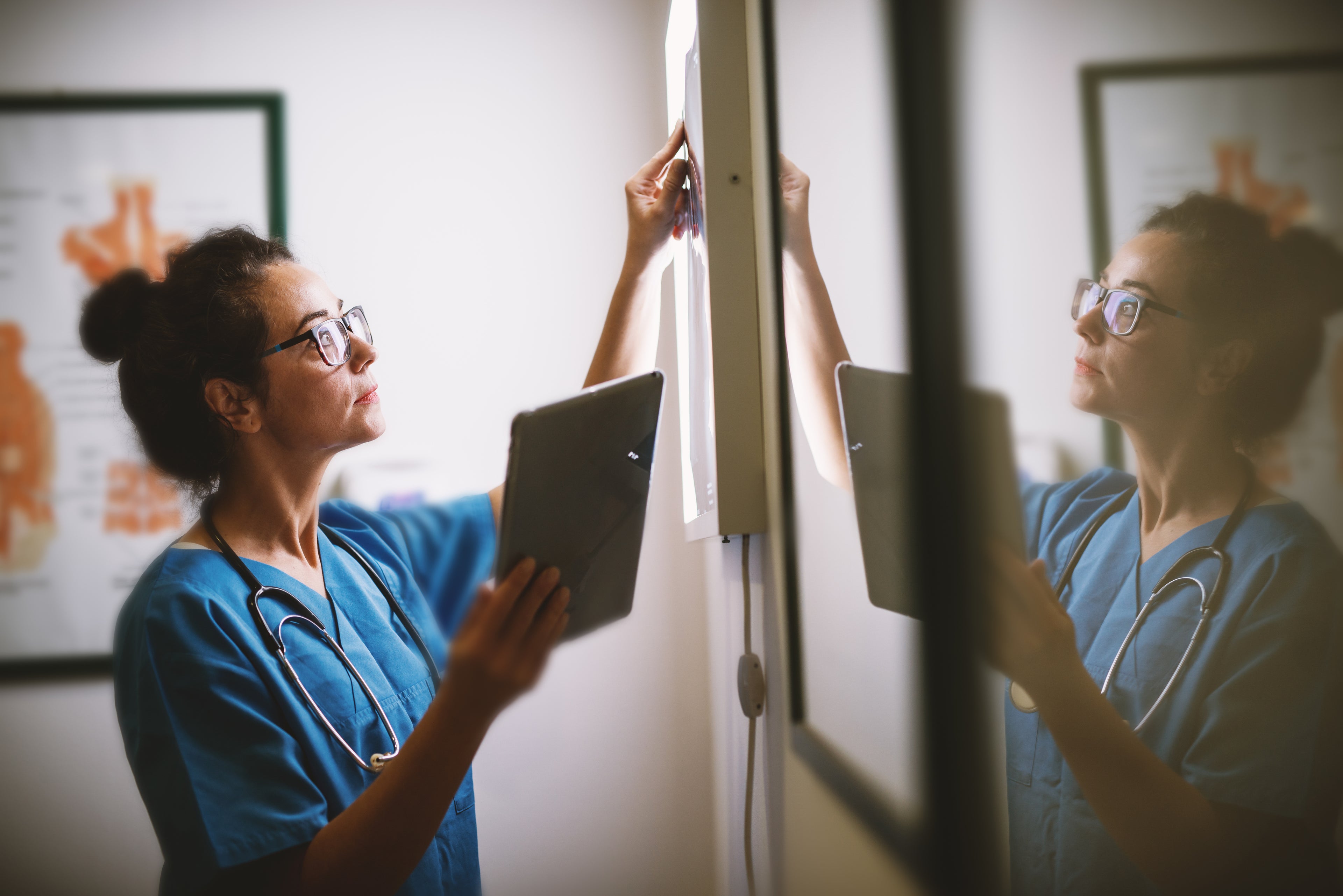 Doctor in hospital looking at charts.