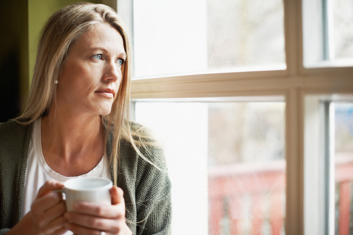 Lady looking out a window dealing with stress of a medico-legal complaint