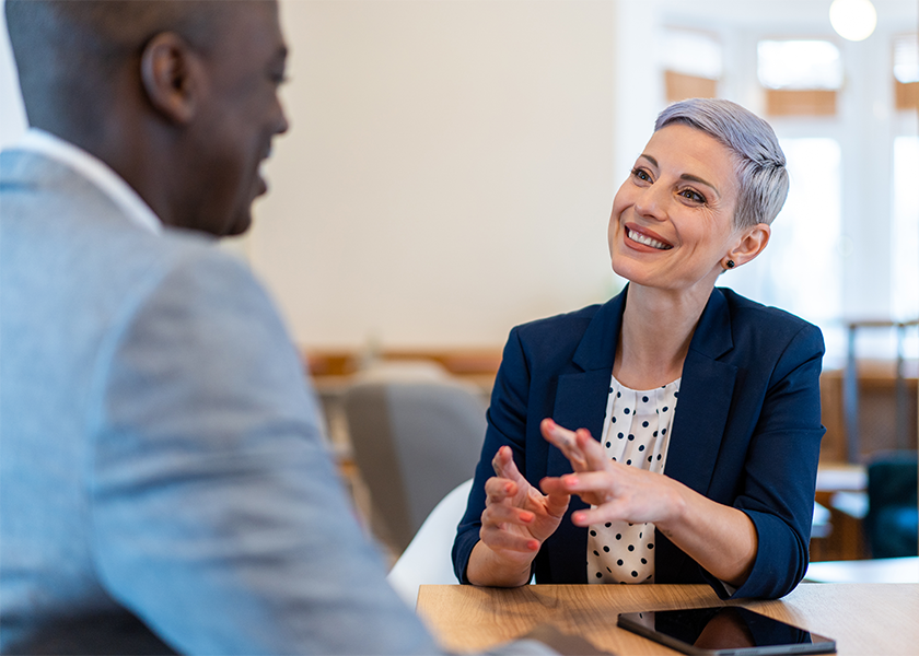 woman smiling and discussing with male client