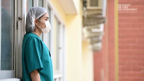 Doctor in scrubs standing outside