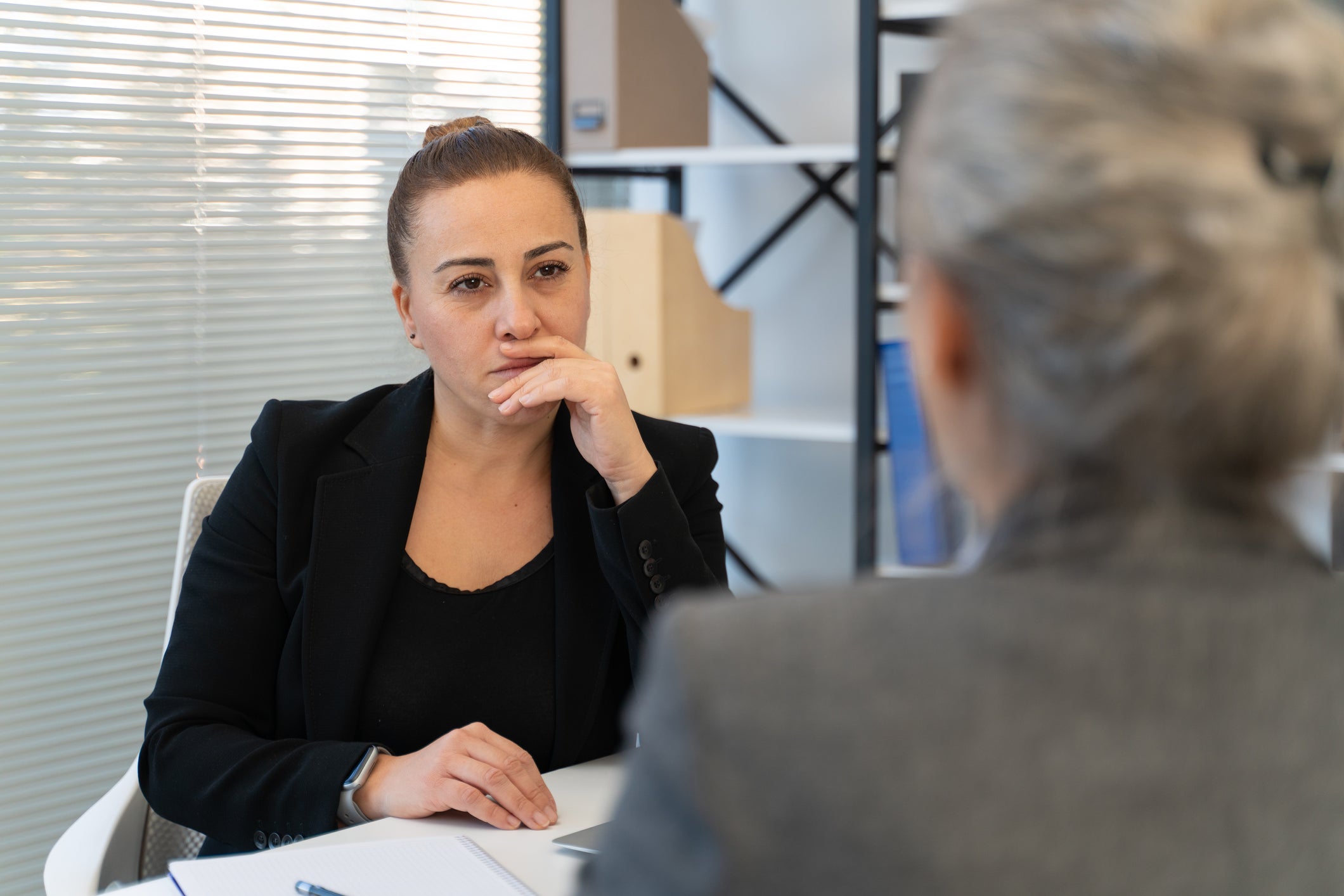 doctor and patient looking contemplative 