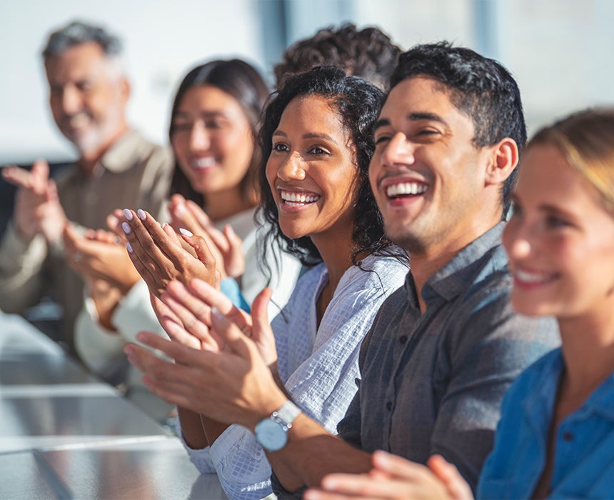 Colleagues clapping each other