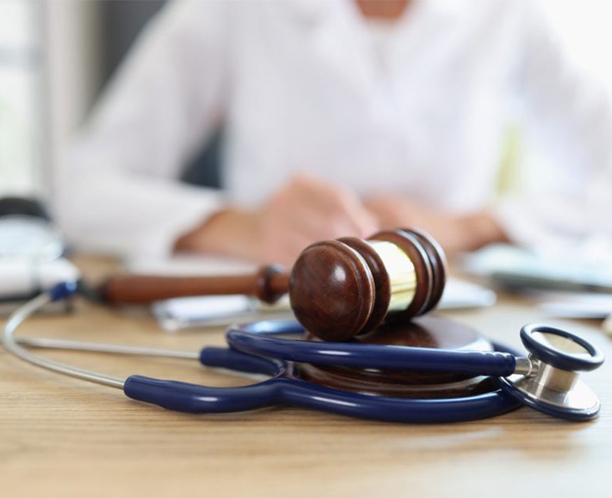 person with gavel and stethoscope