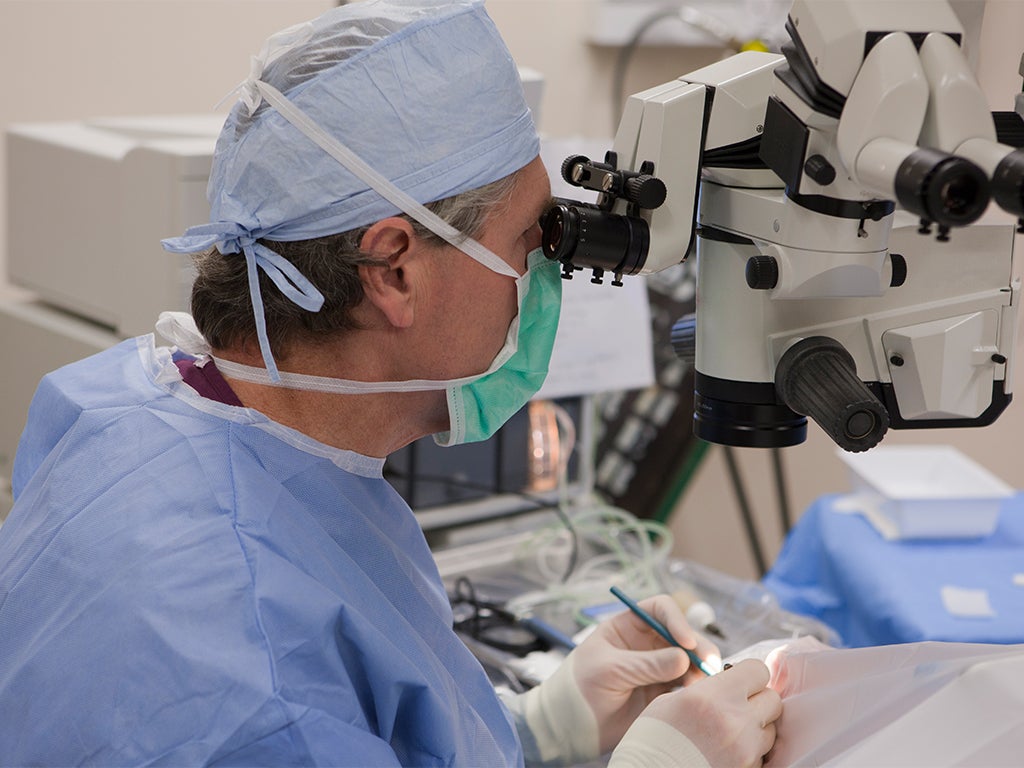 Ophthalmologist looking down a surgical scope