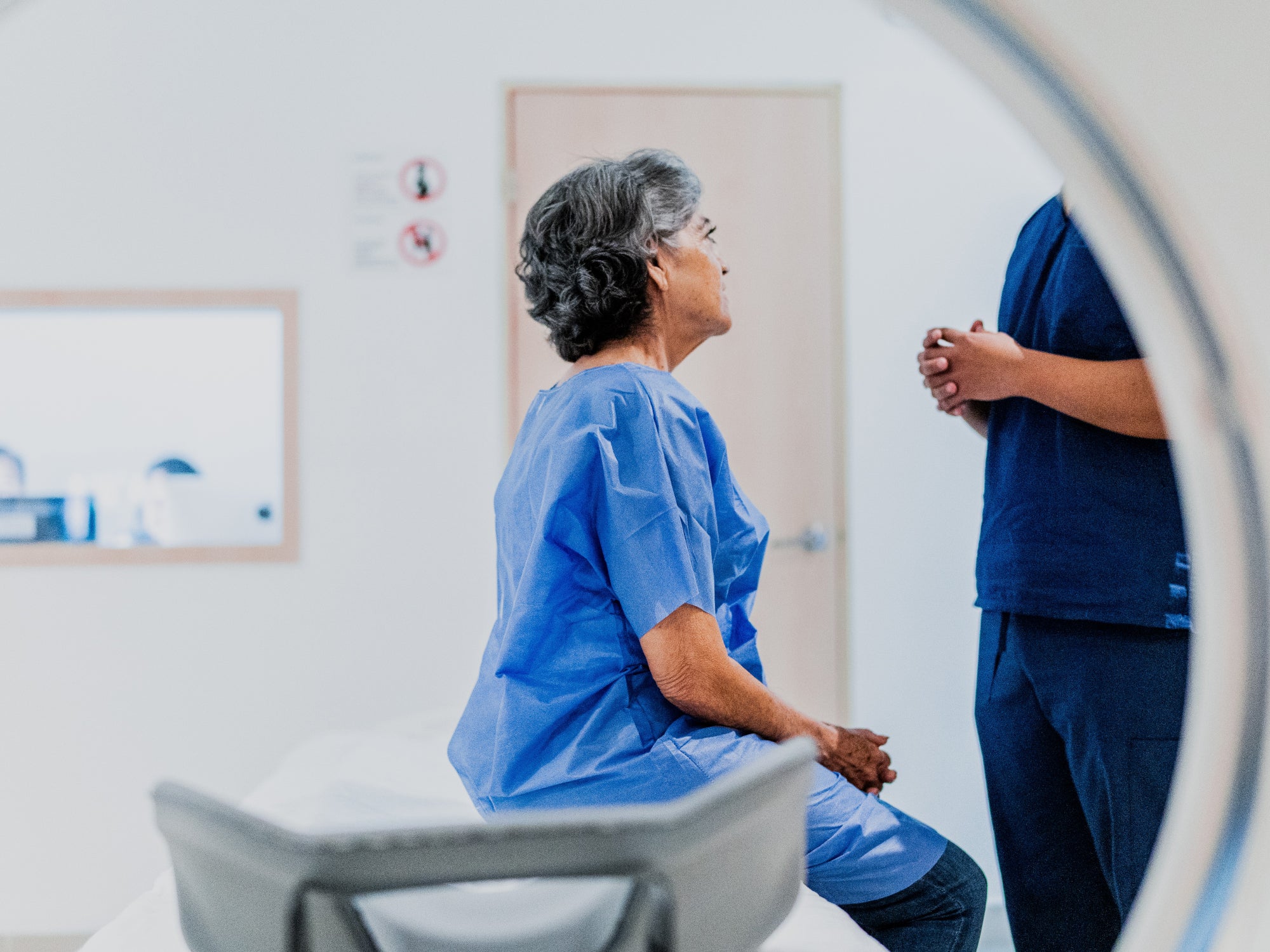 Female sitting talking to doctor in MRI machine