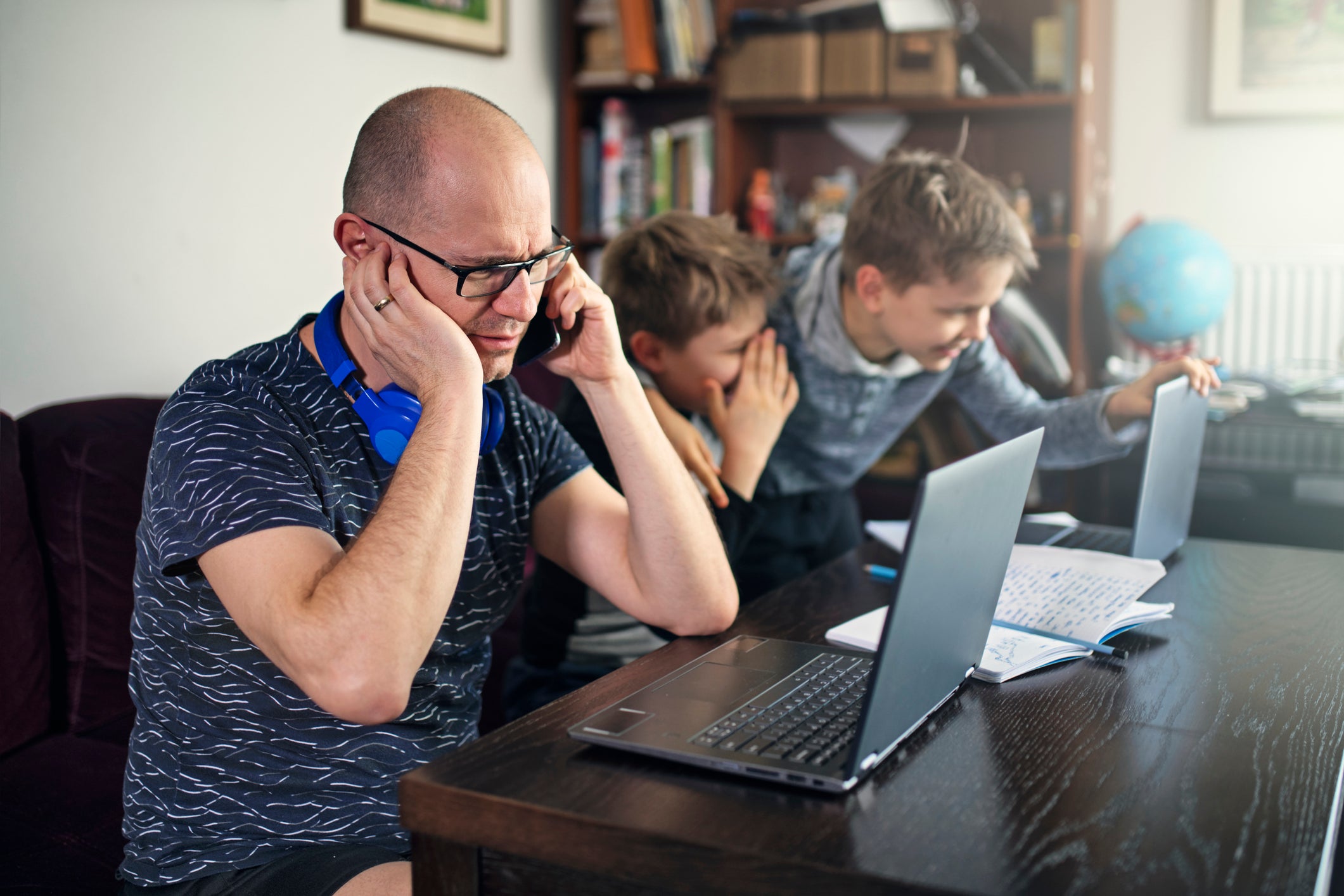 Father on phone while children are yelling