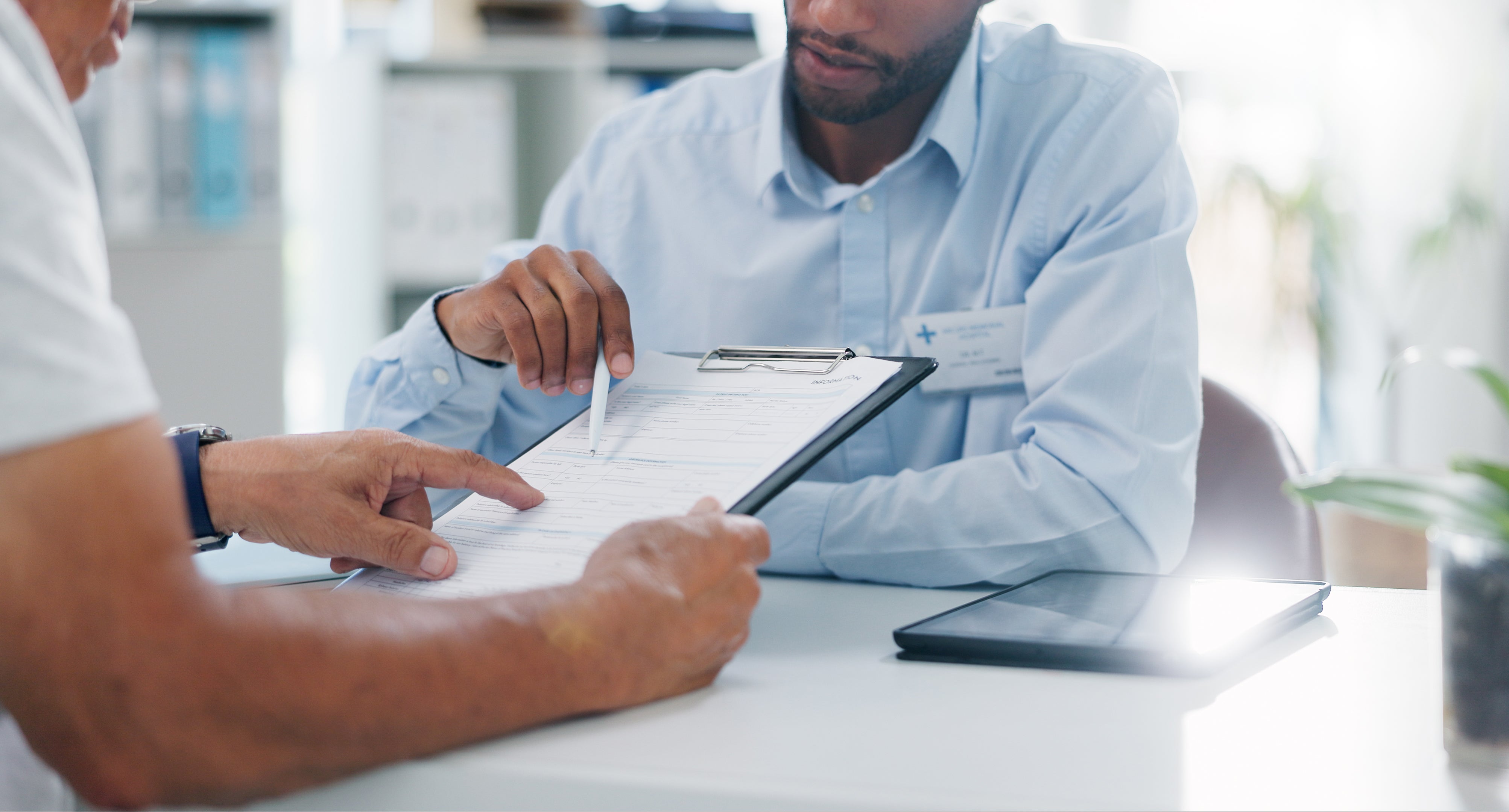 Two people looking at medical chart 