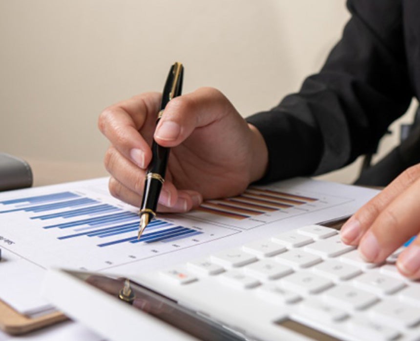 person holding fountain pen assessing results