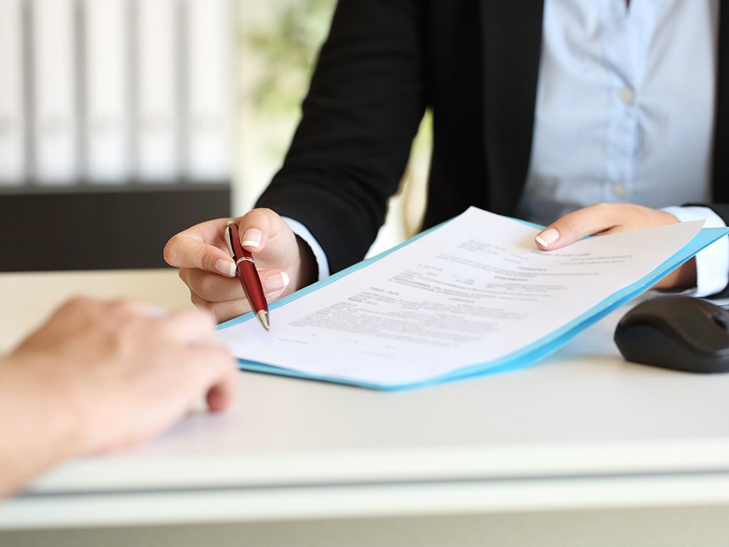 Female presenting legal document to secondary individual