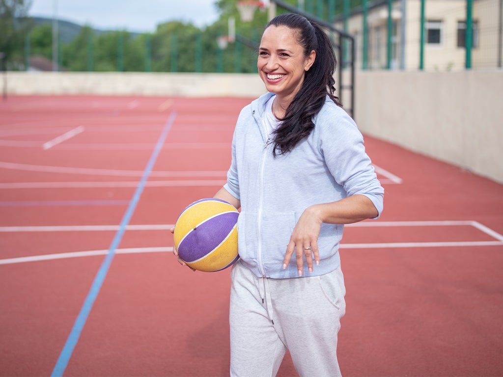 Female basketballer on court holding basketball