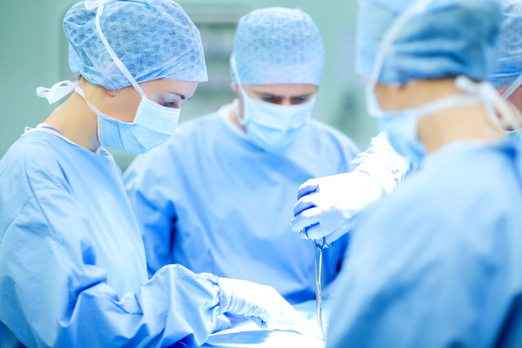 Surgeons in operating theatre