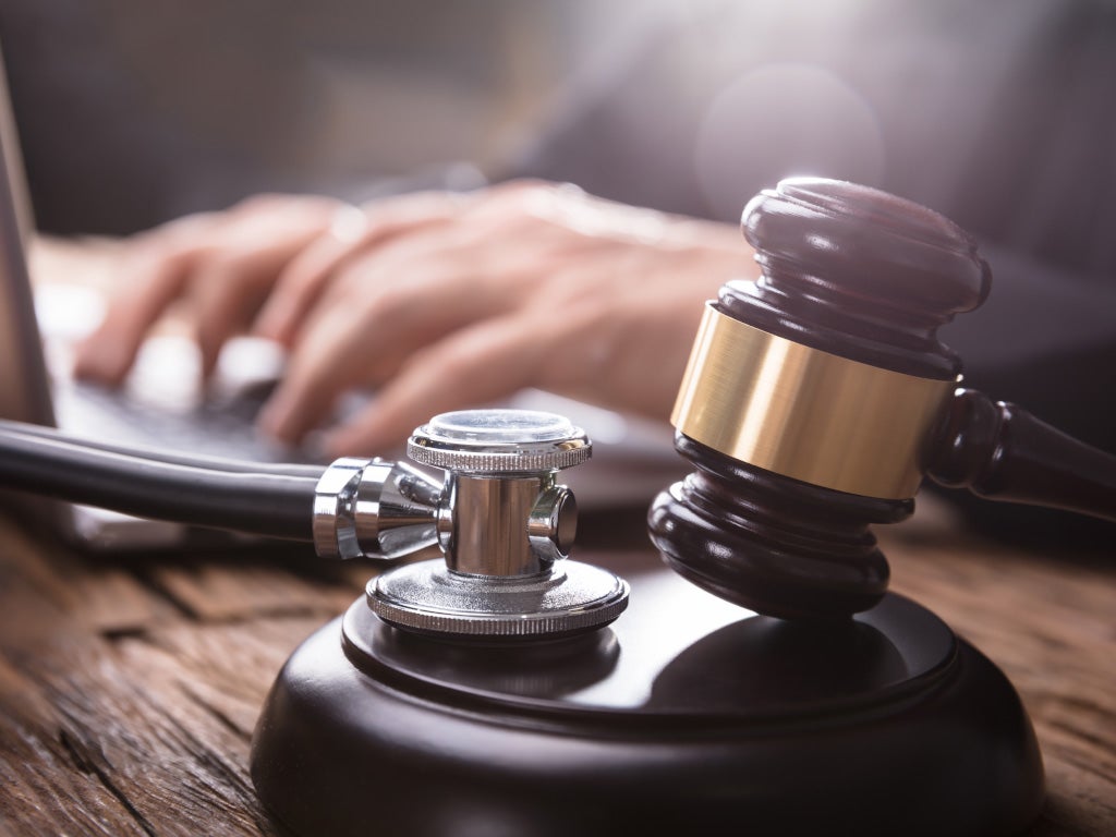 Court gavel next to stethoscope